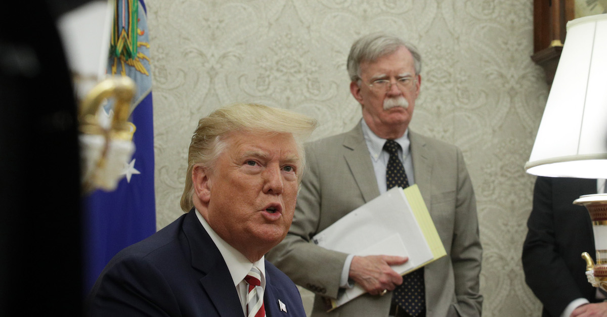 WASHINGTON, DC - AUGUST 20: U.S. President Donald Trump speaks to members of the media as National Security Adviser John Bolton listens during a meeting with President of Romania Klaus Iohannis in the Oval Office of the White House August 20, 2019 in Washington, DC. This is Iohannis‚Äô second visit to the Trump White House and the two leaders are expected to discuss bilateral issues during their meeting.