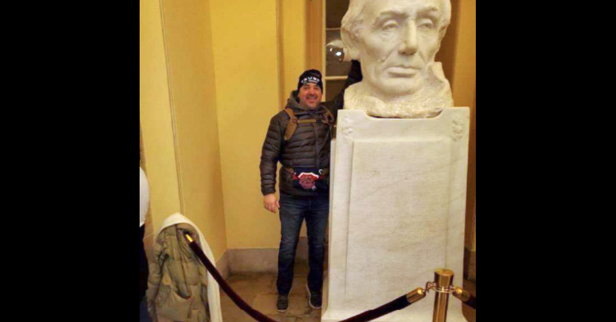 Michael Lee Hardin poses with a bust of Abraham Lincoln in the Capitol on Jan. 6.
