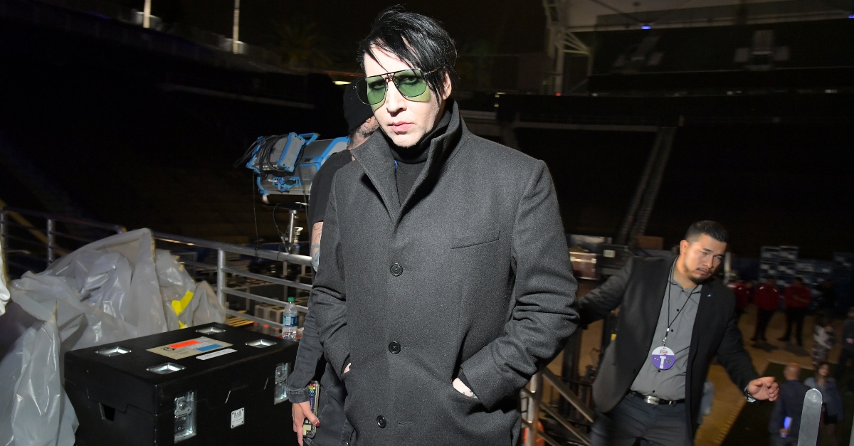 Marilyn Manson in shades and black coat