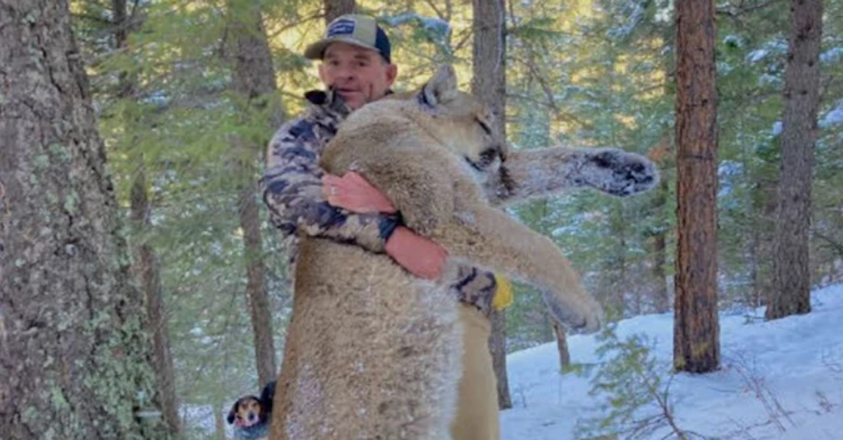 Patrick Montgomery holding up dead moutain lion. copy