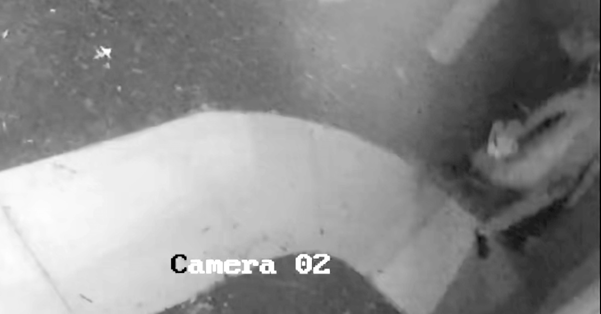 A still frame captured from a surveillance camera shows who prosecutors and law enforcement authorities believe to be alleged murderer Aiden Fucci approaching the front door of his home while carrying his shoes.