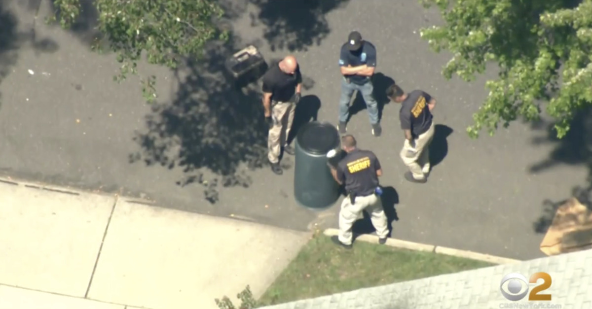 Authorities surround the barrel containing Nicole Flanagan's body