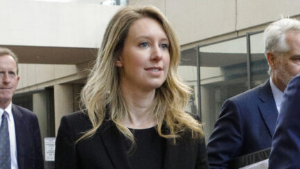 Former Theranos CEO Elizabeth Holmes leaves federal court with her legal team after a status hearing on July 17, 2019 in San Jose, Calif. (Photo by Kimberly White/Getty Images)
