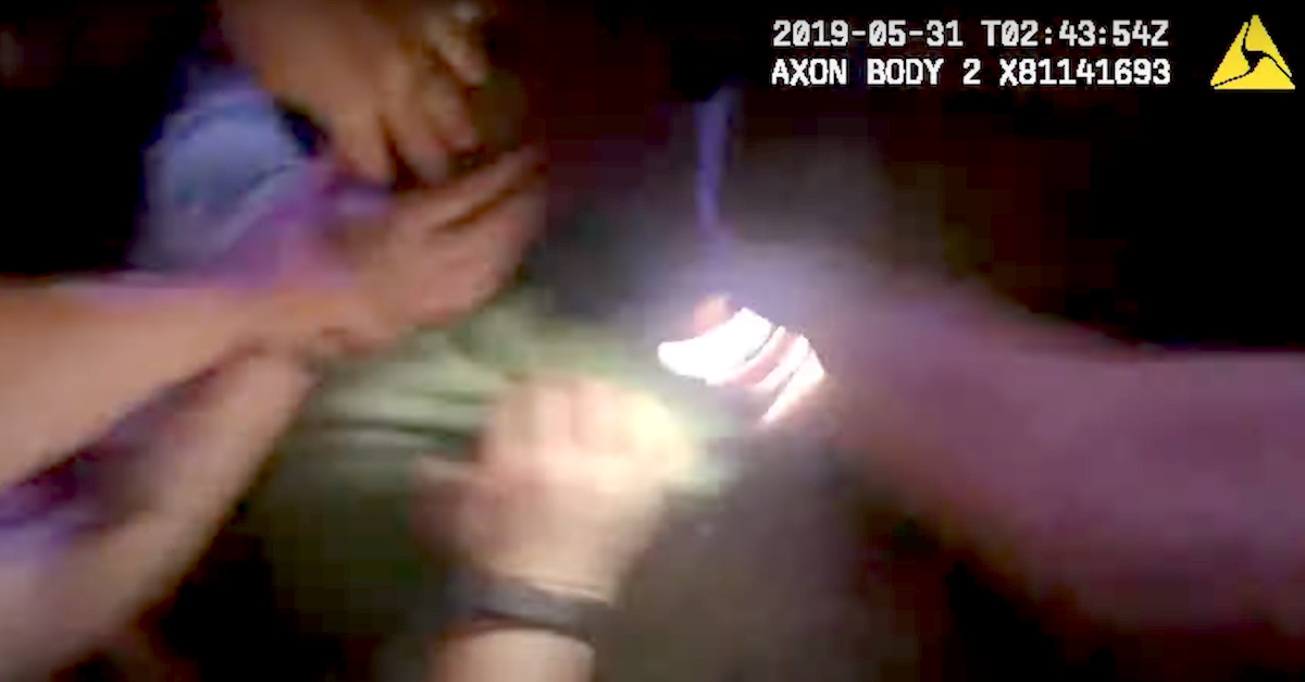 Body camera video shows Aaron Bowman being held by some law enforcement officers while being struck repeatedly by at least one other. 