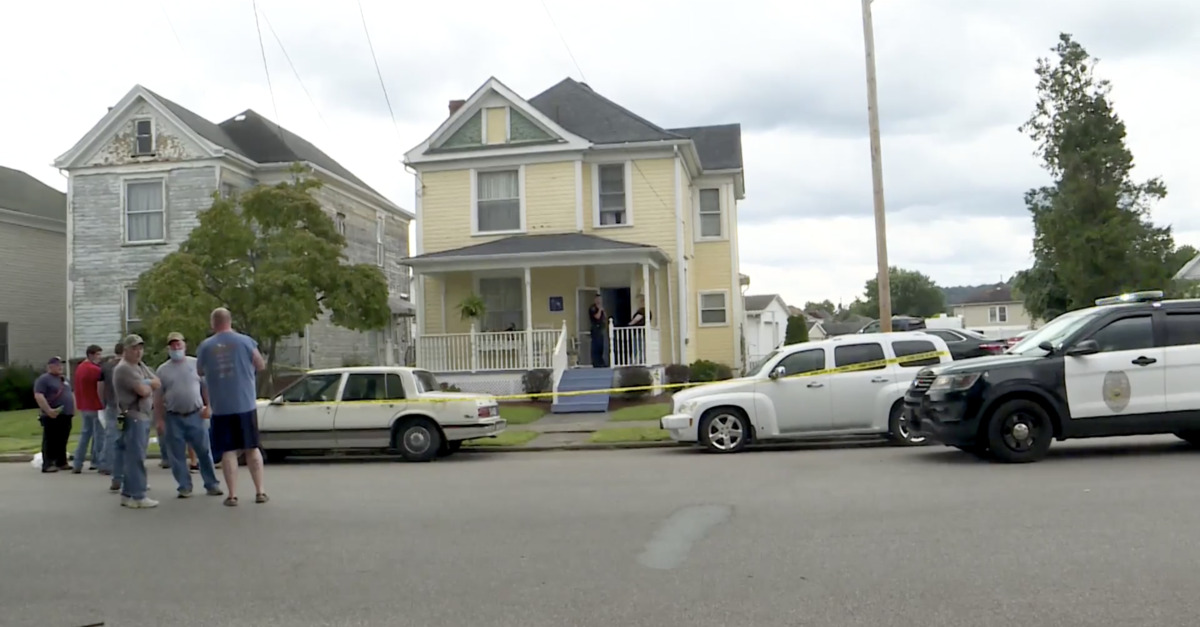 People and police stand around a murder scene in West Virginia