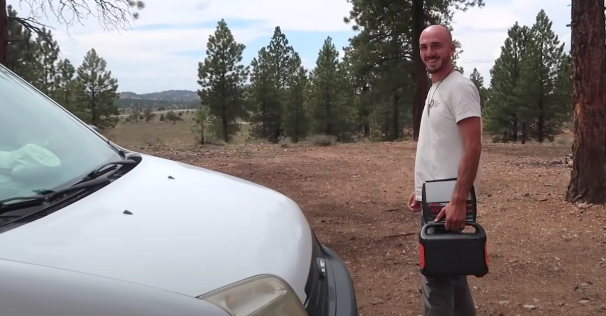 Brian Laundrie is seen after closing the hood of the white van he and Gabby Petito used to travel across the country while documenting their journey online. (Image via screengrab from Nomadic Statik/YouTube.)