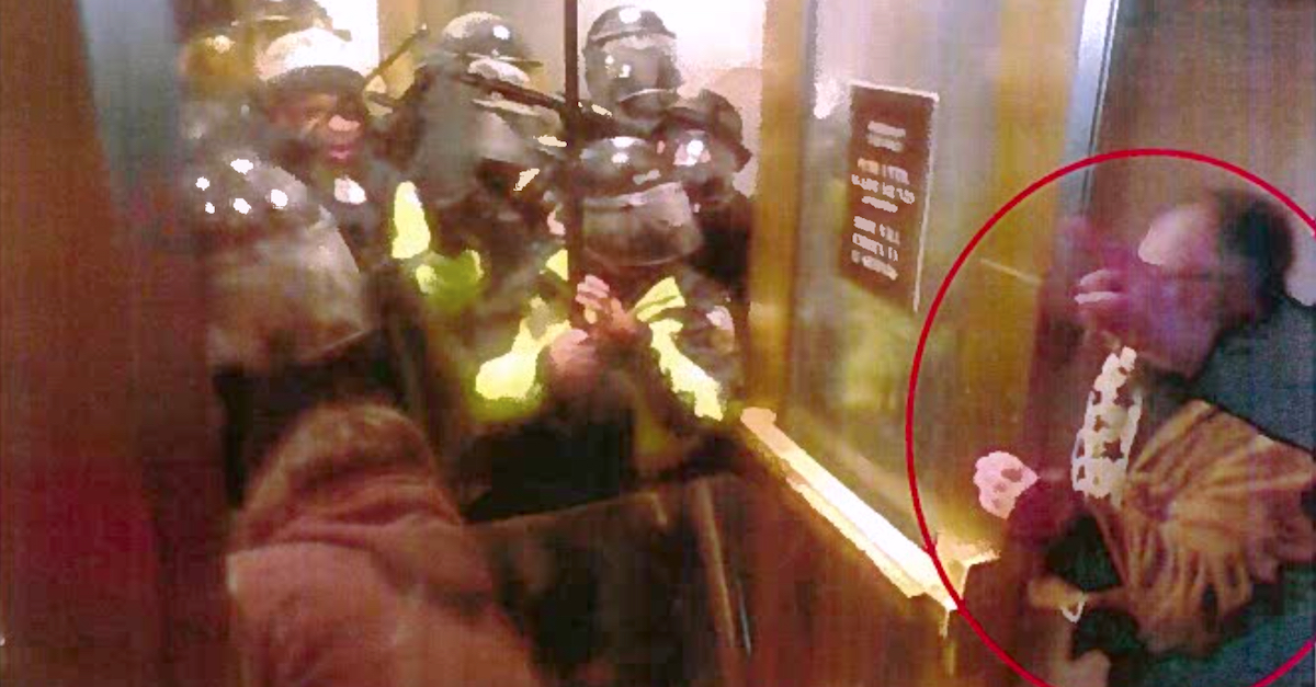 A man alleged to be Mark Mazza (circled in red) holds open a door to the U.S. Capitol Complex on Jan. 6, 2021. (Image via federal court documents.)