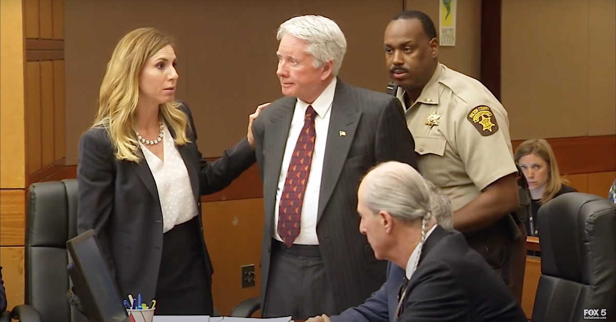 Defense attorney Amanda Clark Palmer (left) comforts Tex McIver moments before he was led from his trial courtroom in handcuffs. Defense attorney Bruce Harvey is seated.