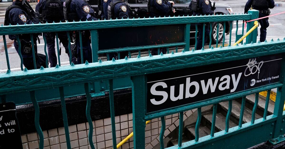 NYPD officers near the site of a mass shooting on the NYC Subway system
