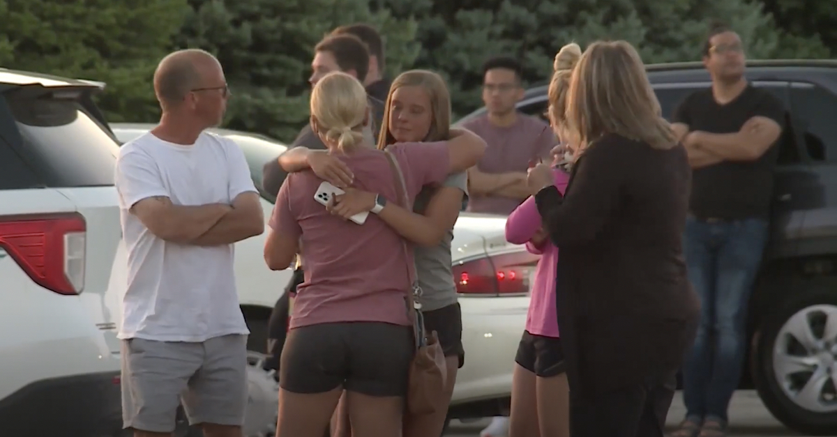 People embracing in the aftermath of the shooting at Cornerstone Church.
