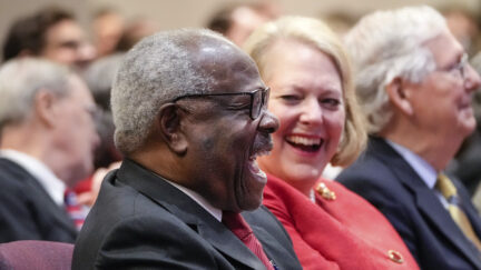 Justice Clarence Thomas sits with his wife, conservative activist Virginia Thomas, while he waits to speak at the Heritage Foundation on October 21, 2021 in Washington, D.C. (Photo by Drew Angerer/Getty Images.)
