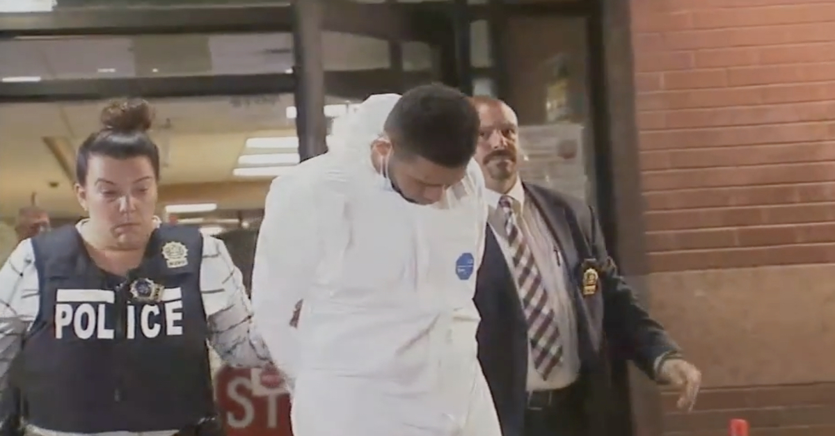 Argenis Baez being escorted by NYPD oficers (WABC-TV screengrab)