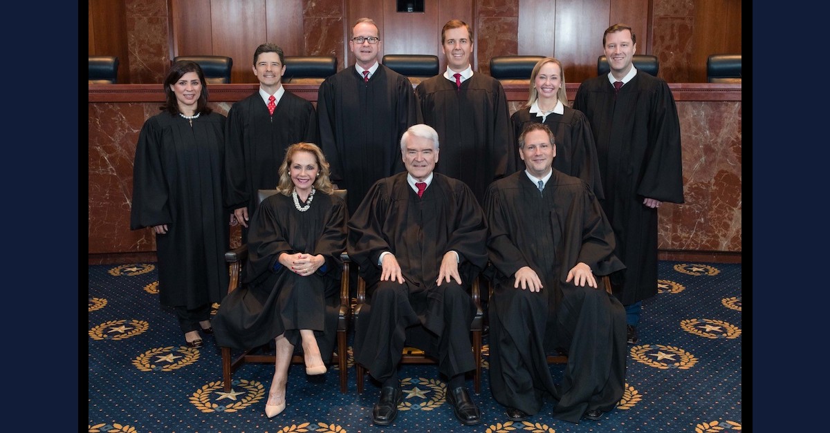 The Texas Supreme Court appears in an official portrait. Front row: Justice Debra Lehrmann, Chief Justice Nathan L. Hecht, and Justice Jeff Boyd. Back row: Justices Rebeca Aizpuru Huddle, Brett Busby, John Phillip Devine, Jimmy Blacklock, Jane Bland, and Evan A. Young.