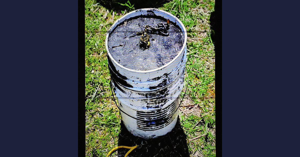 A photo shows a bucket filled with concrete.