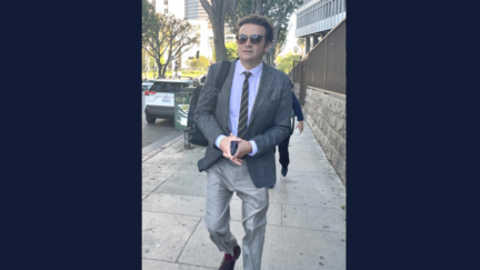 Danny Masterson in a suit and shades, walking outside the courthouse