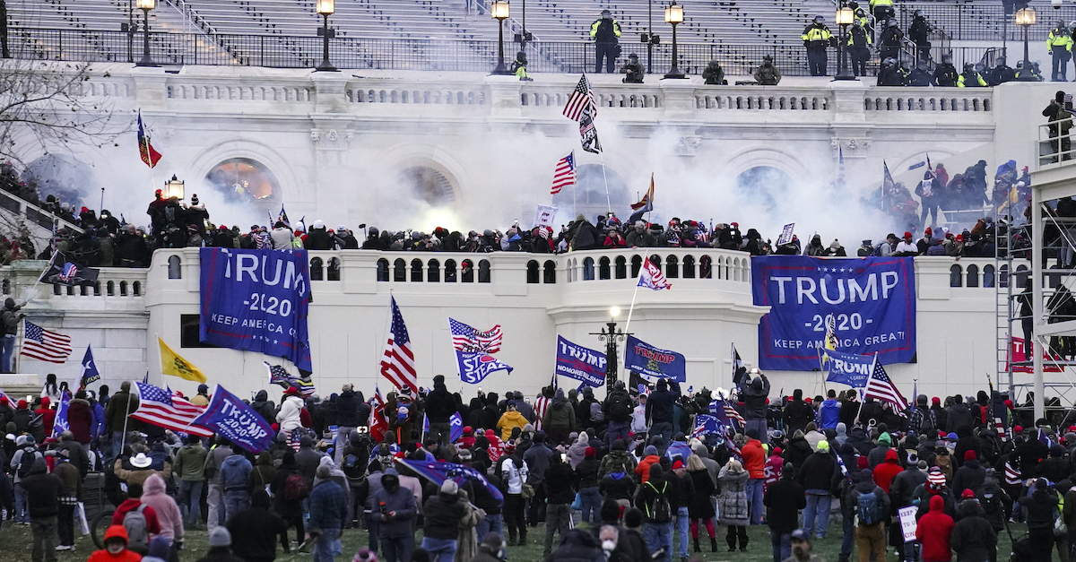 Smoke rises from outside the Capitol building on Jan. 6 as a crowd of Donald Trump supporters descends on the building.