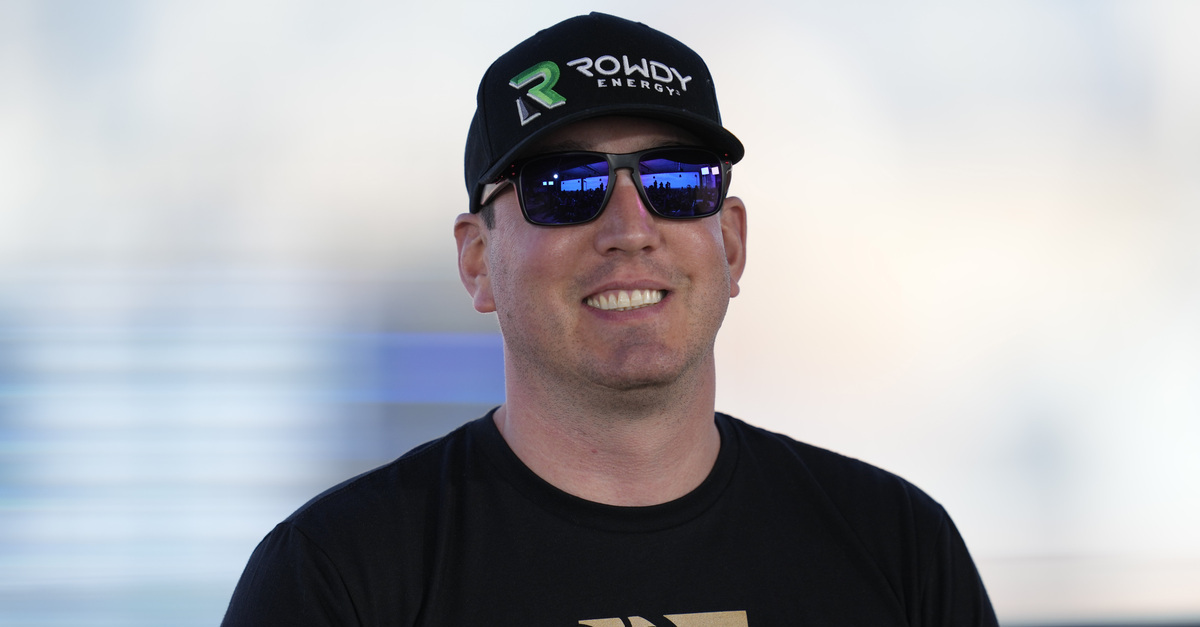 Kyle Busch smiles in a photograph while wearing sunglasses and a hat