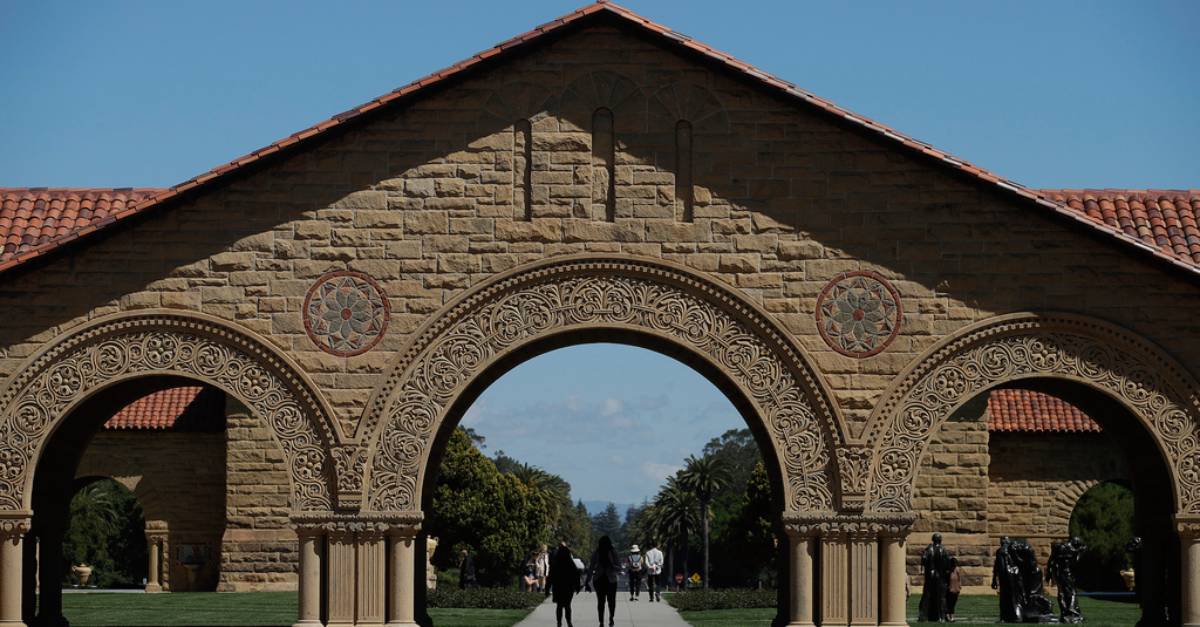 FILE - Pedestrians walk on the campus of Stanford University in Stanford, California April 9, 2019. Prosecutors say a 25-year-old Stanford University employee has been arrested and charged with perjury for allegedly lying about his marriage twice last year had been raped on campus. Santa Clara County prosecutors say Jennifer Gries reported false sexual assaults on nurses, who are required by law to notify law enforcement, in August and again in October. (AP Photo/Jeff Chiu, file)