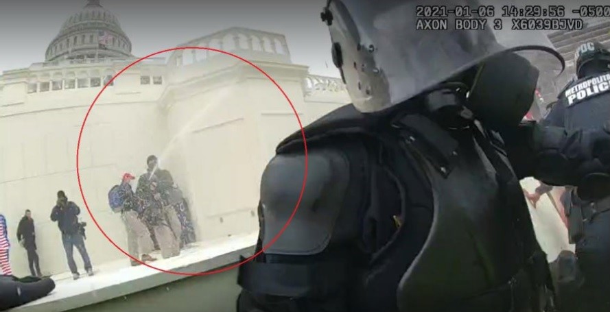 DOJ exhibit photo allegedly showing Gregory Yetman, circled in red, using a spraying device to douse police at the U.S. Capitol with OC and/or pepper spray. 