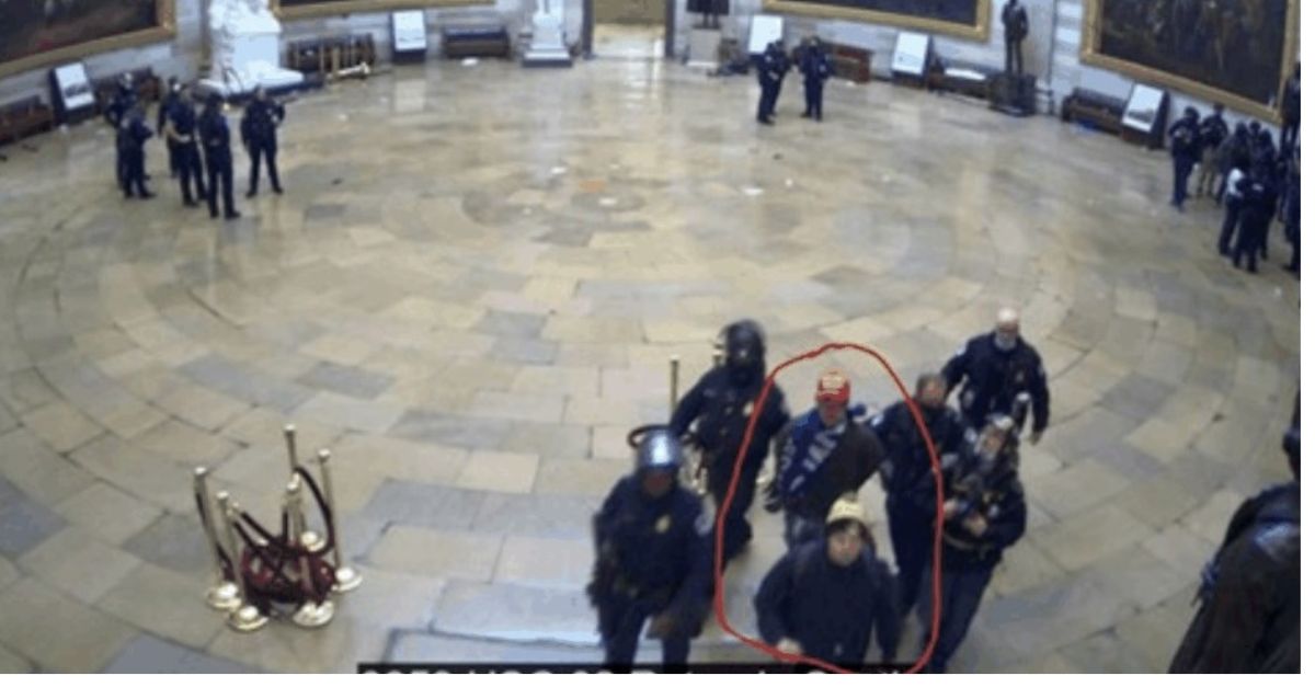 A lawyer for Alexander Fan says his client, circled in red, appears here being willingly escorted out of the Capitol rotunda on Jan. 6, 2021. 