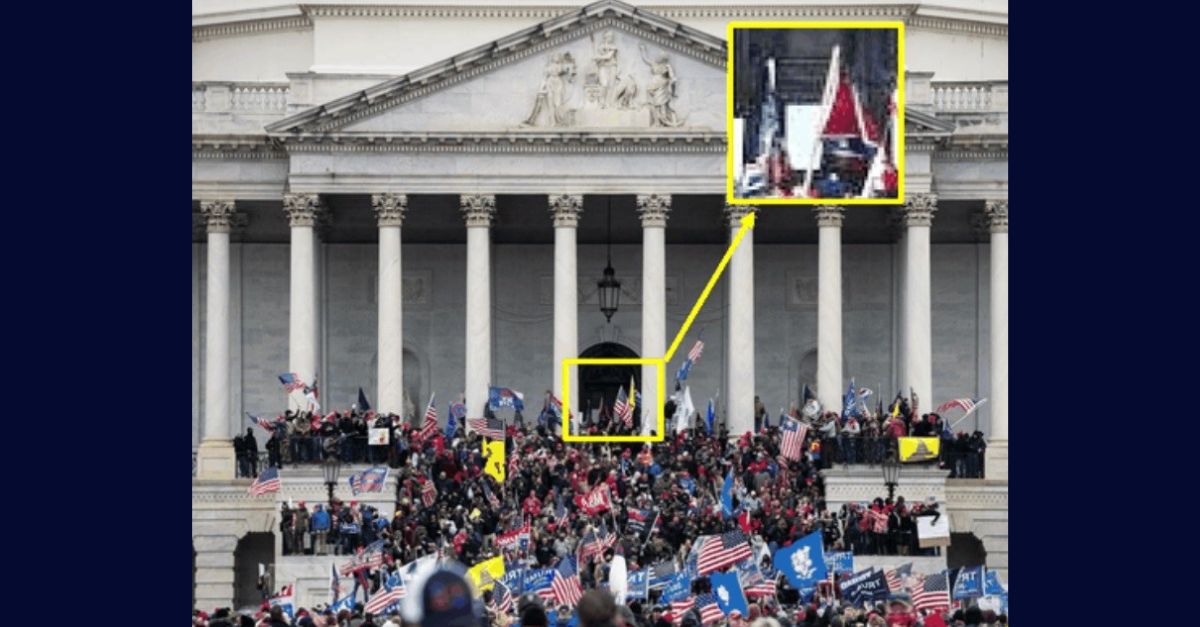 A Justice Department provided photo of the exterior of the U.S. Capitol on Jan. 6, 2021, shows Isreal Easterday, highlighted by a yellow box in the exhibit, carrying a Confederate flag as he tries to breach the Capitol.