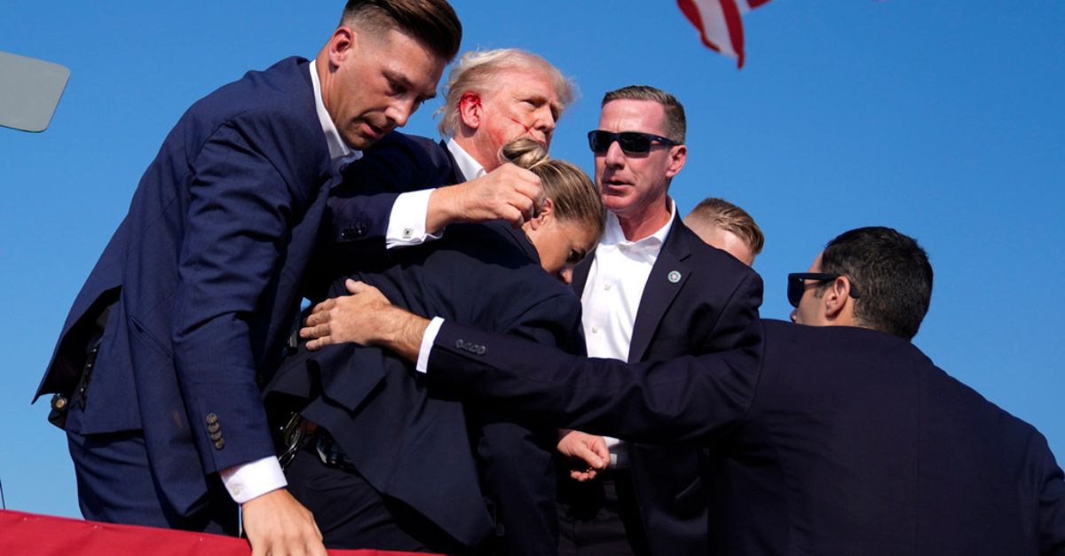 Trump visibly bleeding after shots ring out at rally