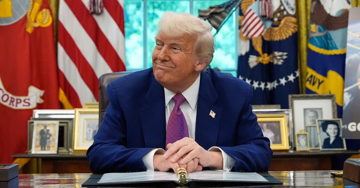 Donald Trump smiles in the White House.