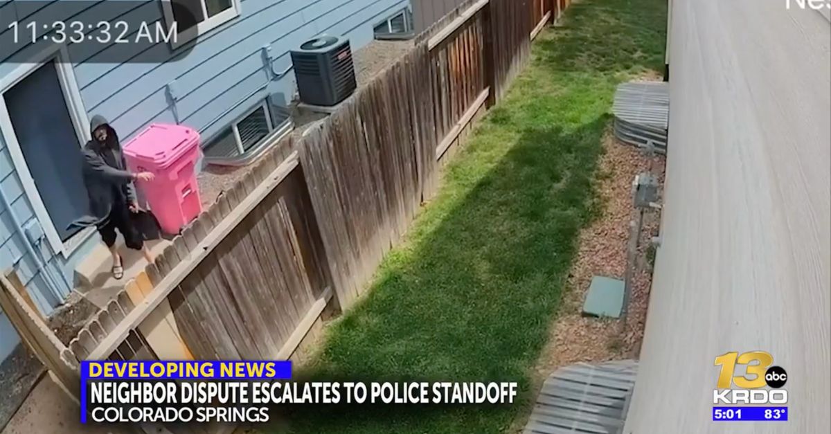 A man throws small objects at a home in Colorado.