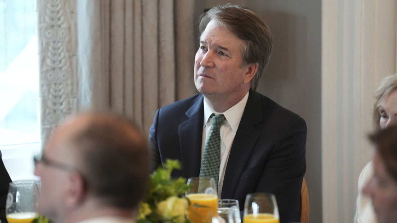 Brett Kavanaugh listens to a speaker while seated.