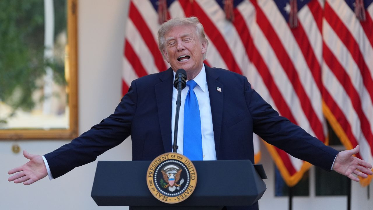 Donald Trump spreads his arms.