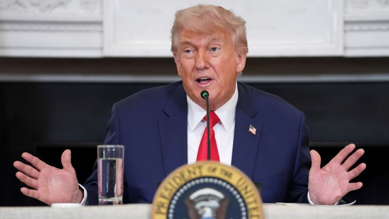 Donald Trump raises his hands.
